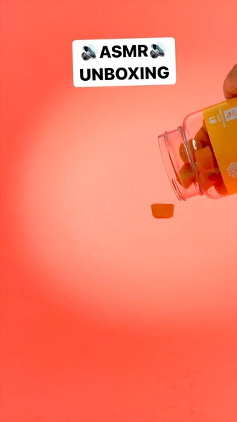 A high-contrast vertical ad featuring a vitamin gummy bottle pouring product into frame, using sensory ASMR text cues.